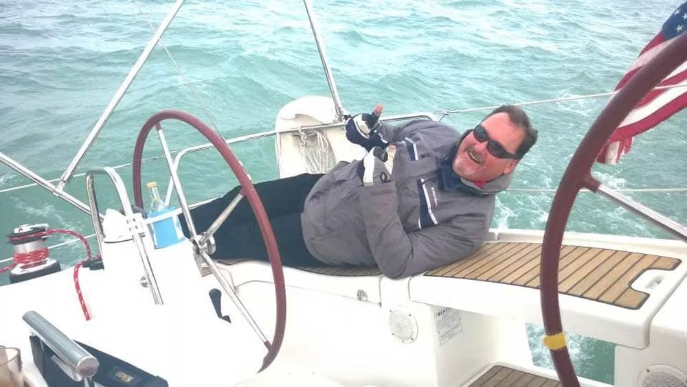 Captain Jeff at the helm on a Chicago sailboat charter on Lake Michigan