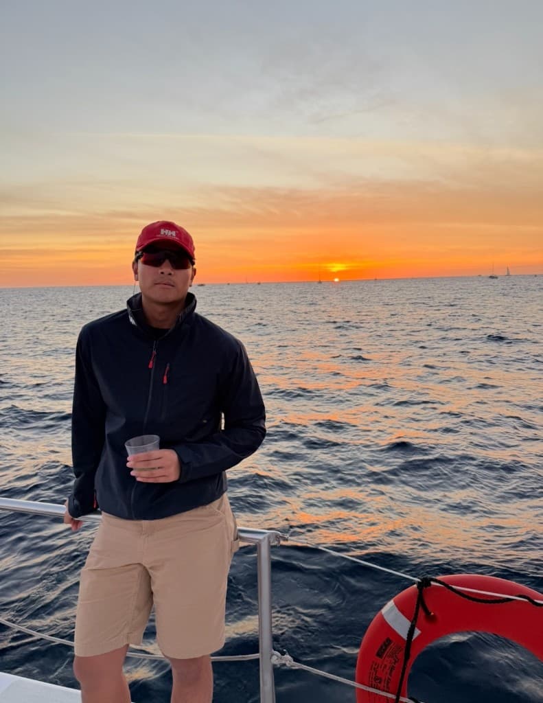 Cedrick, first mate on a Chicago sailboat charter on Lake Michigan at sunset